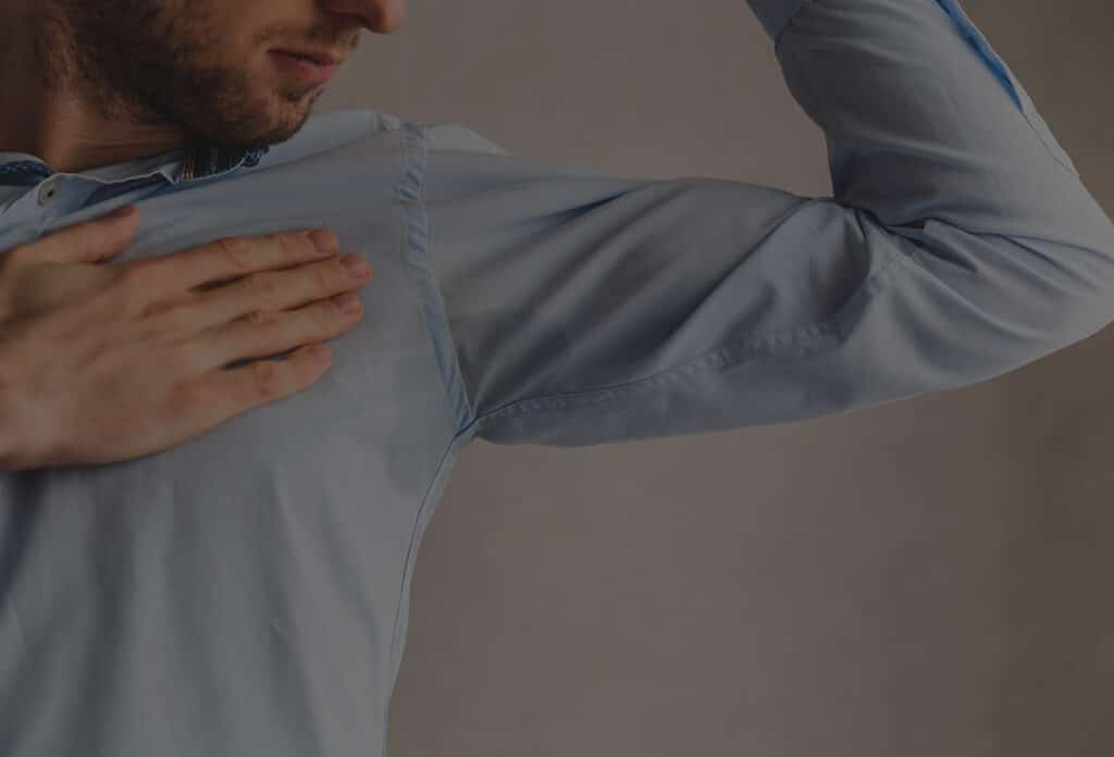 man experiencing excessive sweating